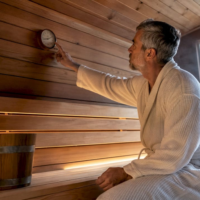 Man checking temperature in traditional sauna