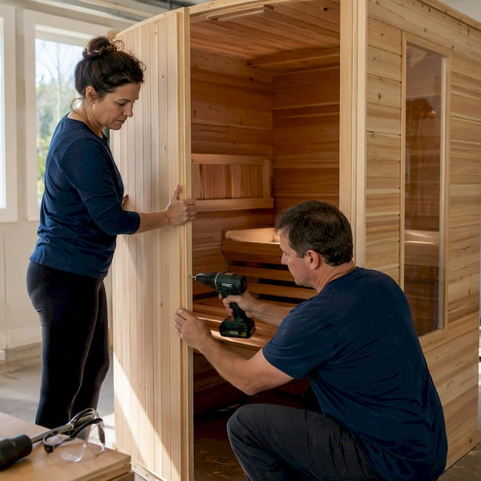 Couple installing home sauna kit indoors
