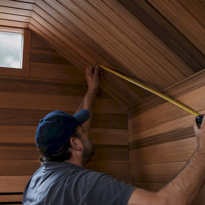 Measuring sauna room length with tape