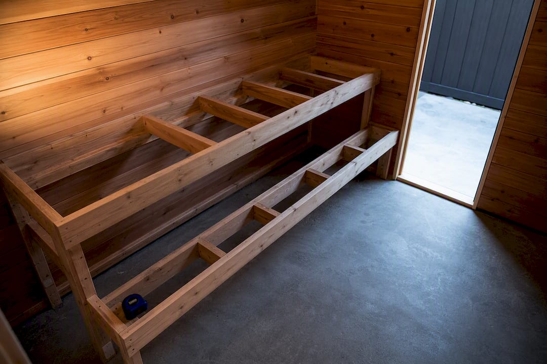 Unfinished sauna room with tiered bench layout
