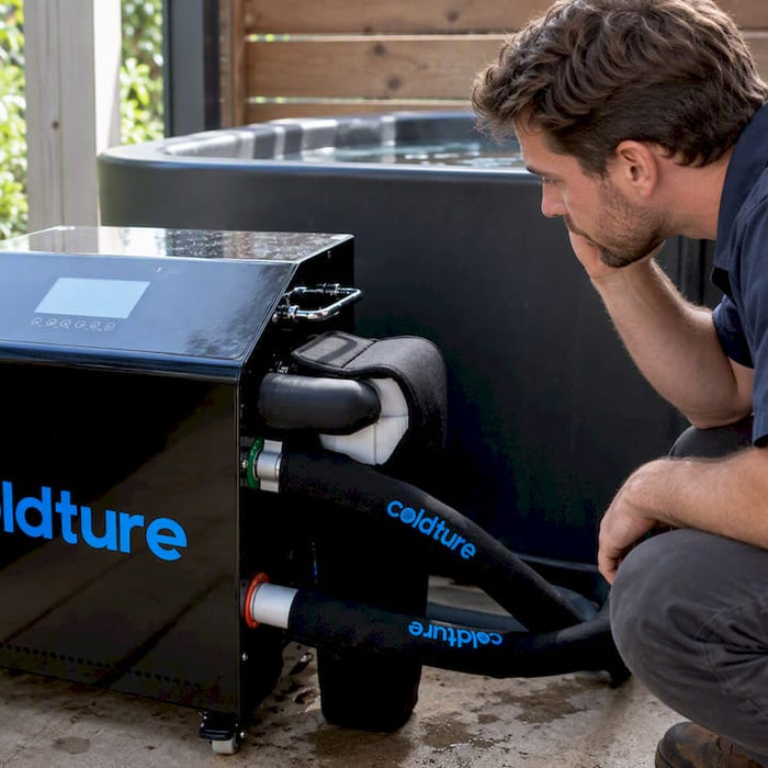 Technician listening beside a Coldture chiller