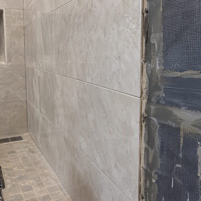Steam shower tile beside exposed vapor membrane