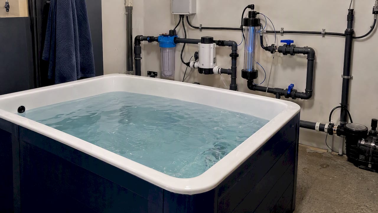 Cold plunge tub beside ozone and chlorine equipment