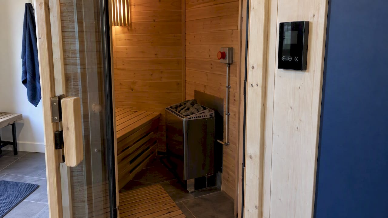 Sauna heater and safety switch by doorway